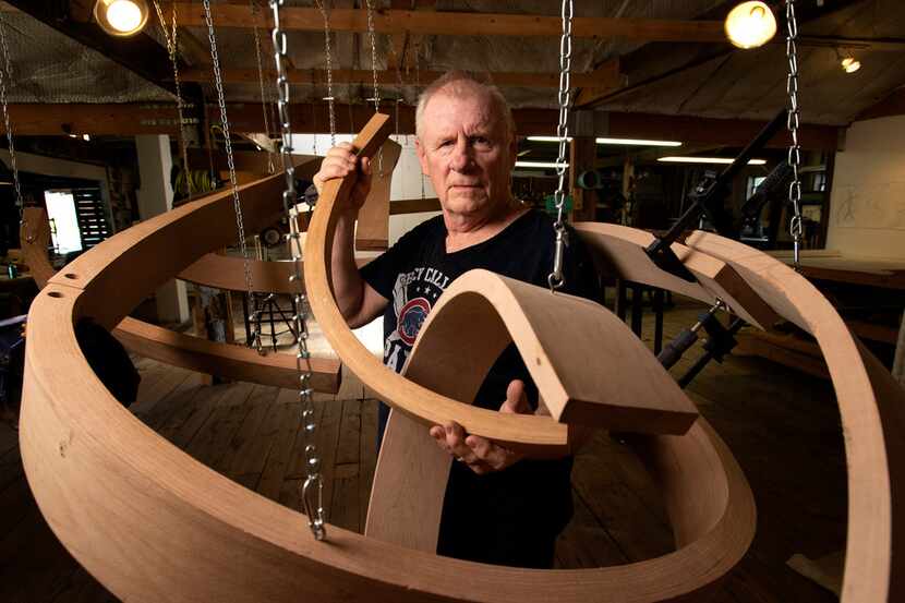 Wood sculptor Rick Maxwell poses with an unfinished sculpture at his studio in The Cedars...