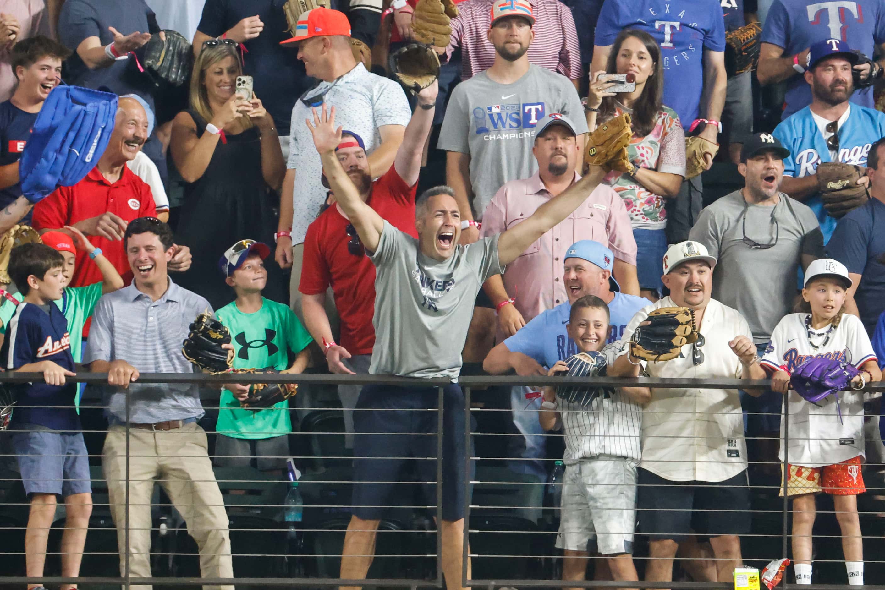 A baseball fan cheers after catching a homerun ball hit by Jose Ramirez, of the Cleveland...