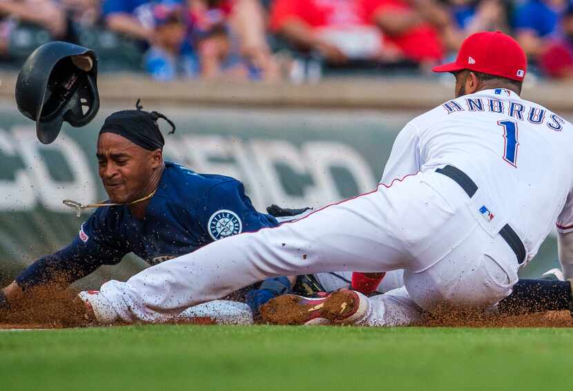 Seattle Mariners right fielder Mallex Smith (0) gets past the tag from Texas Rangers...