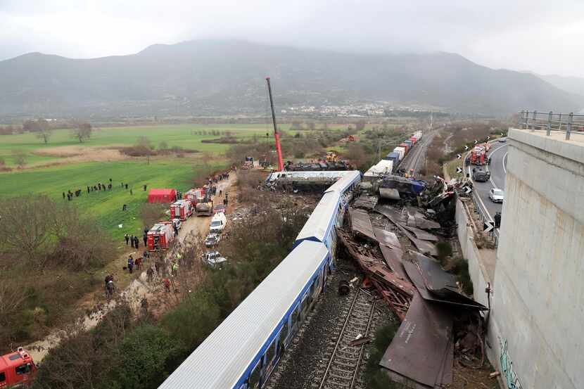 A crane operator, firefighters and rescue personnel work the scene of the accident. The...