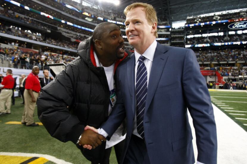 Former NFL player Warren Sapp (left) greets NFL commissioner Roger Goodell.