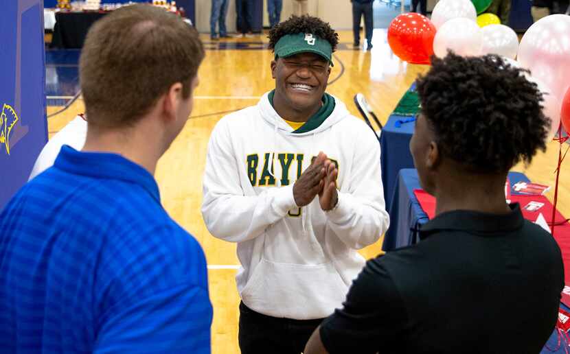 Wide receiver Solomon Turner, center, talks to his teammates before National Signing Day...