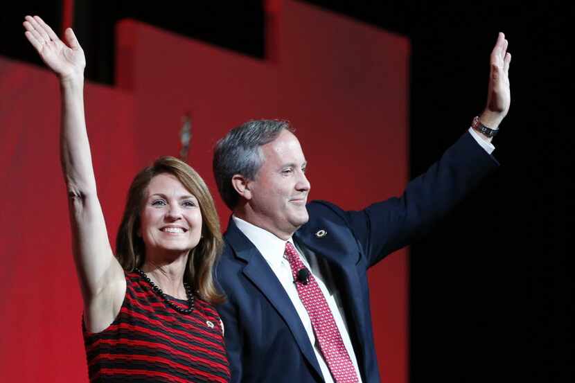 Texas Attorney General Ken Paxton and wife Angela Paxton wave to the crowd during the 2016...