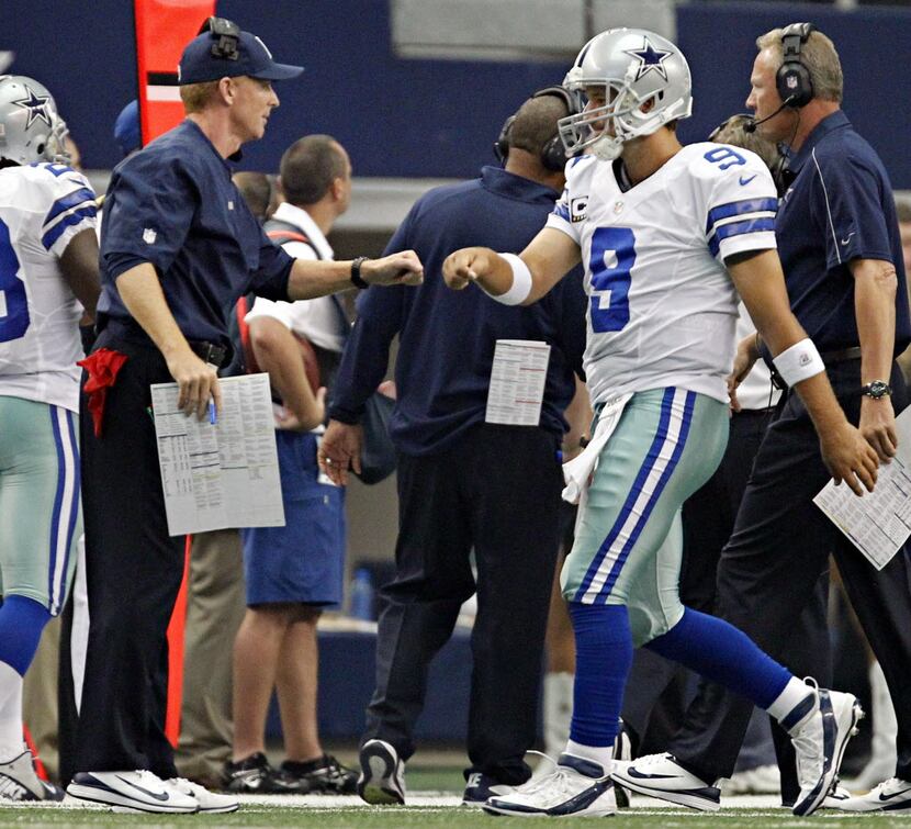 Dallas Cowboys head coach Jason Garrett (left) and quarterback Tony Romo first bump after a...