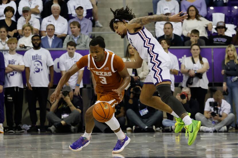 TCU guard Micah Peavy, right, fouls Texas guard Max Abmas (3) during the second half of an...