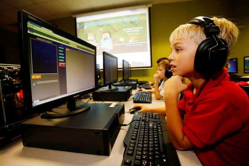 
Cody McDowell works with a Minecraft coding website at a meeting of the after-school coding...