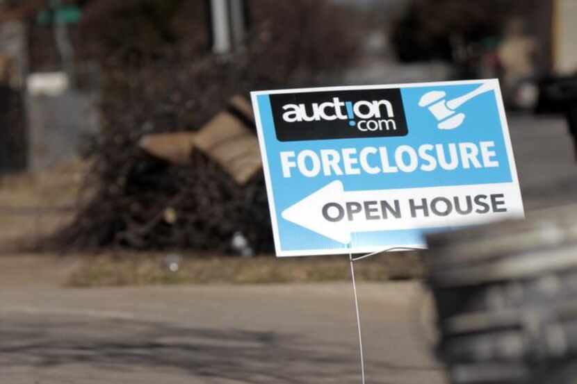 A sign advertised an open house for a foreclosed home in Old East Dallas last year.