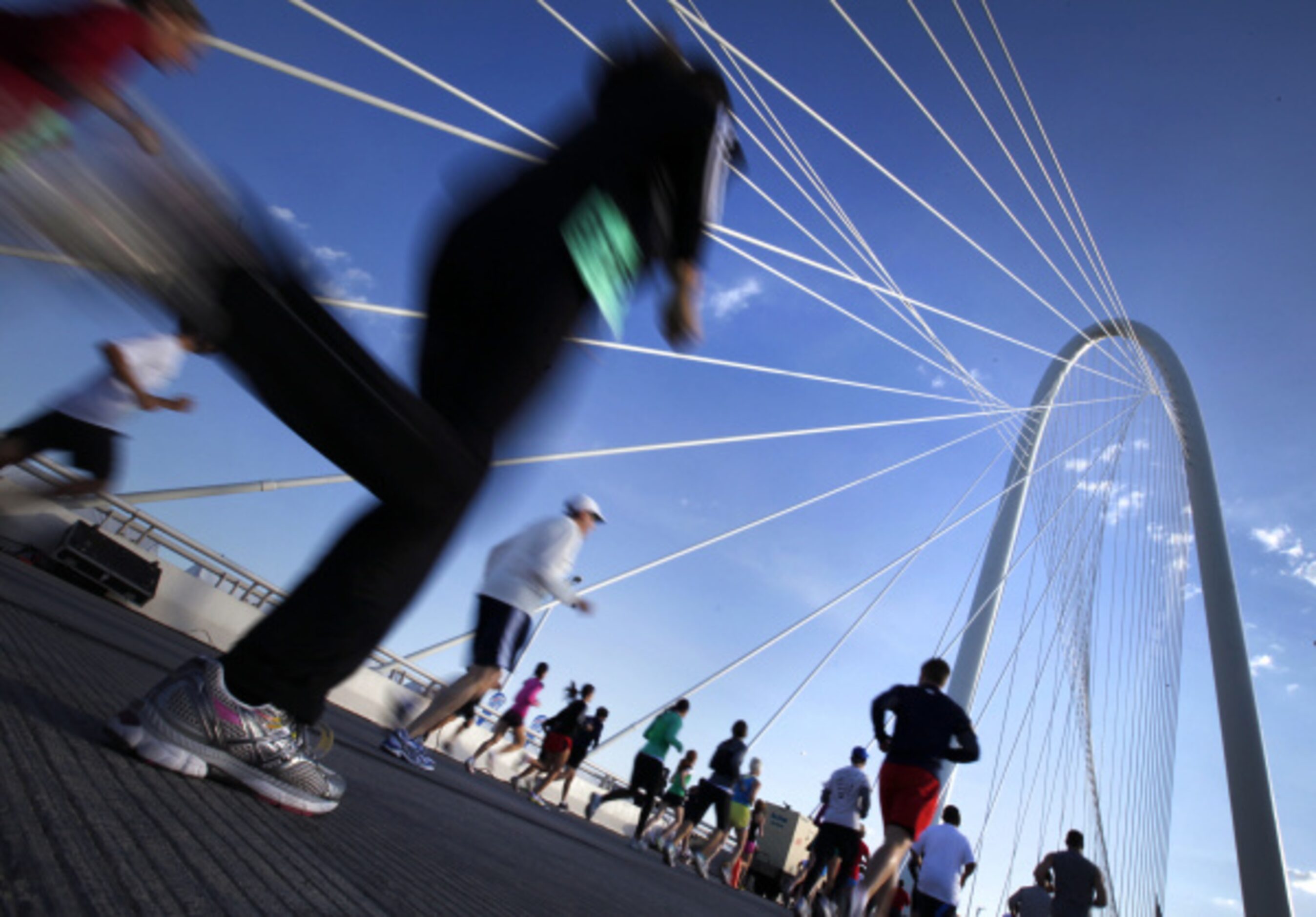 Participants run over the Margaret Hunt Hill Bridge in Dallas, TX during Trinity Sprint...