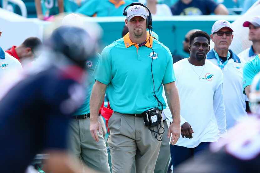 Oct 25, 2015; Miami Gardens, FL, USA; Miami Dolphins head coach Dan Campbell (C) looks on...