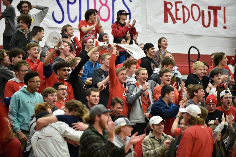 Argyle students cheer after their team scores on a last-second shot against Krum in a game...