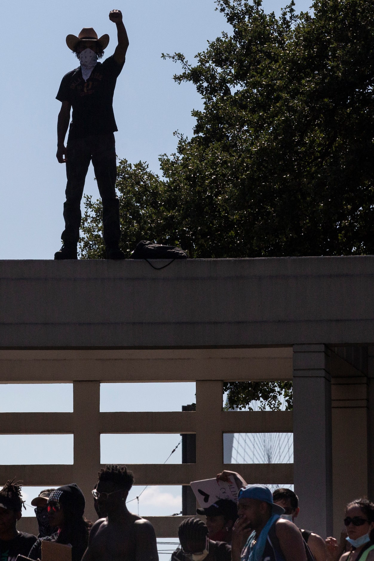 Protesters gather at The Grassy Knoll during a demonstration denouncing police brutality and...