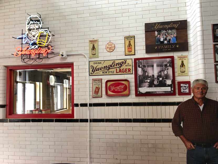 Vintage signs, photos and a cardboard cutout of owner Dick Yuengling decorate the bar that's...