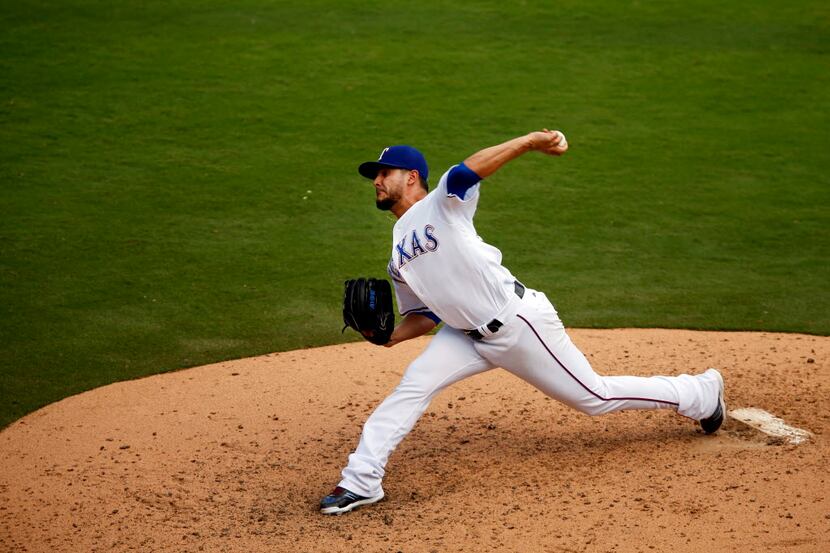 Texas Rangers starting pitcher Martin Perez (33) throws against the Seattle Mariners in the...