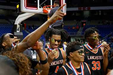 Lancaster's Dillon Battie (4) and Amari Reed (33) admire their medals after winning the UIL...