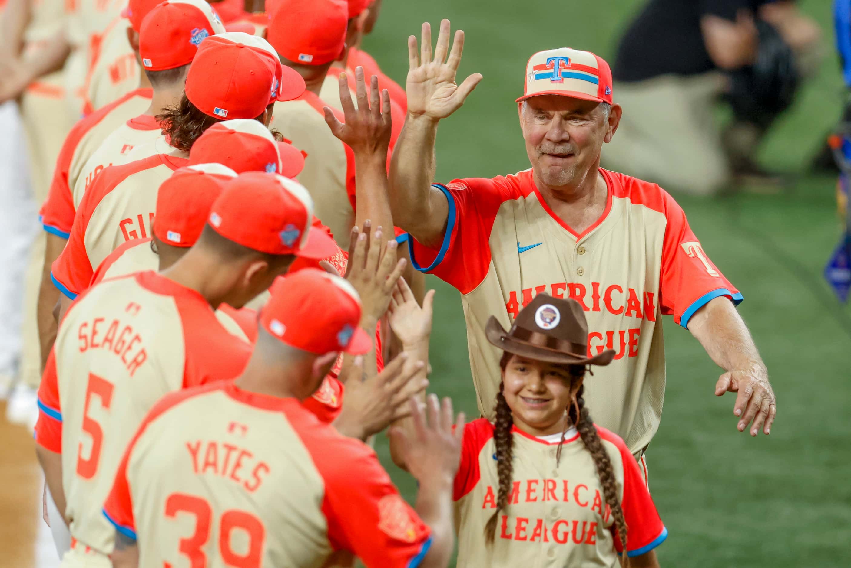 American League manager Bruce Bochy, of the Texas Rangers, high-fives American League...