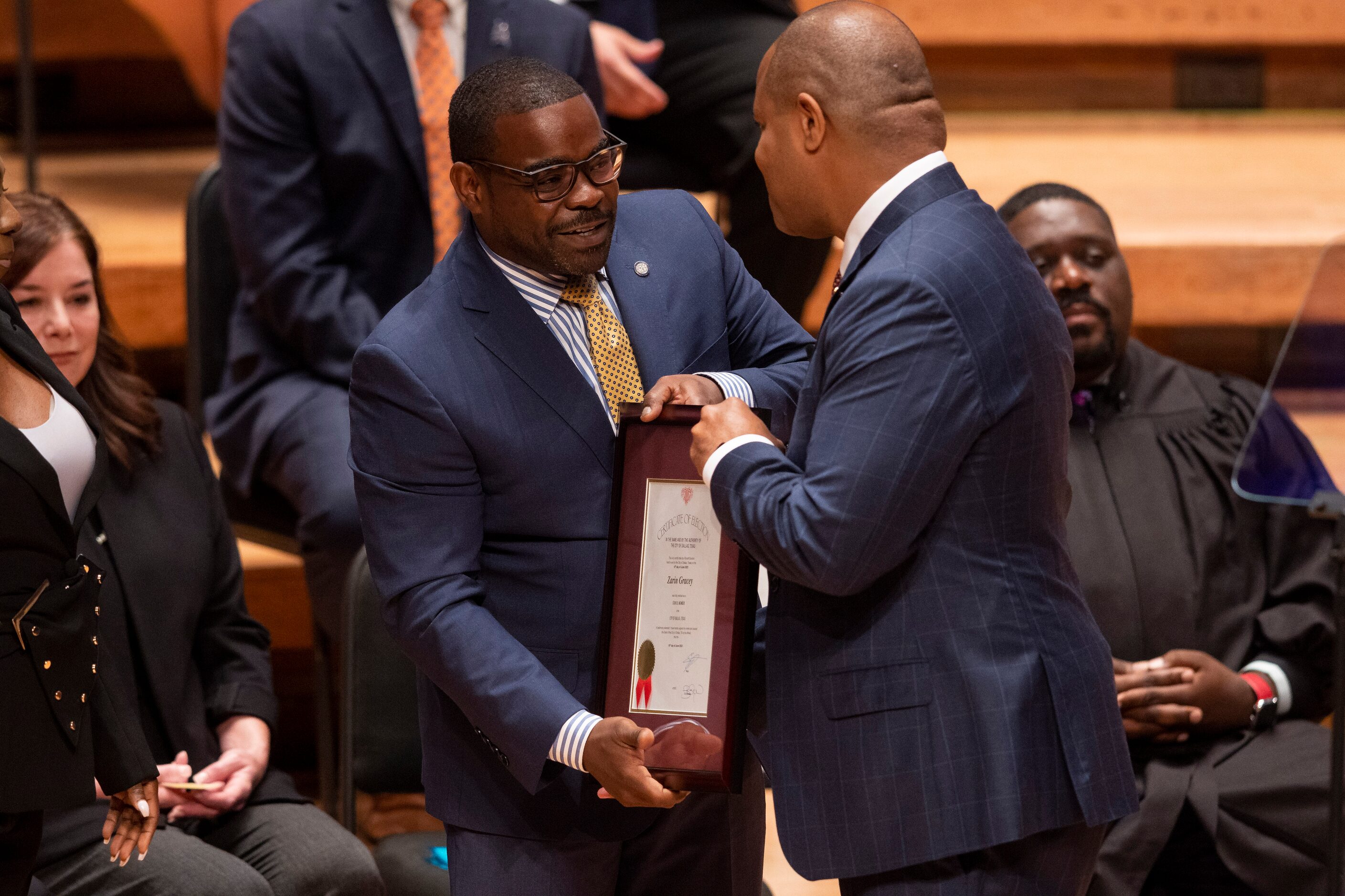 Incoming Dallas City council member Zarin Gracey, District 3, collects his certificate of...