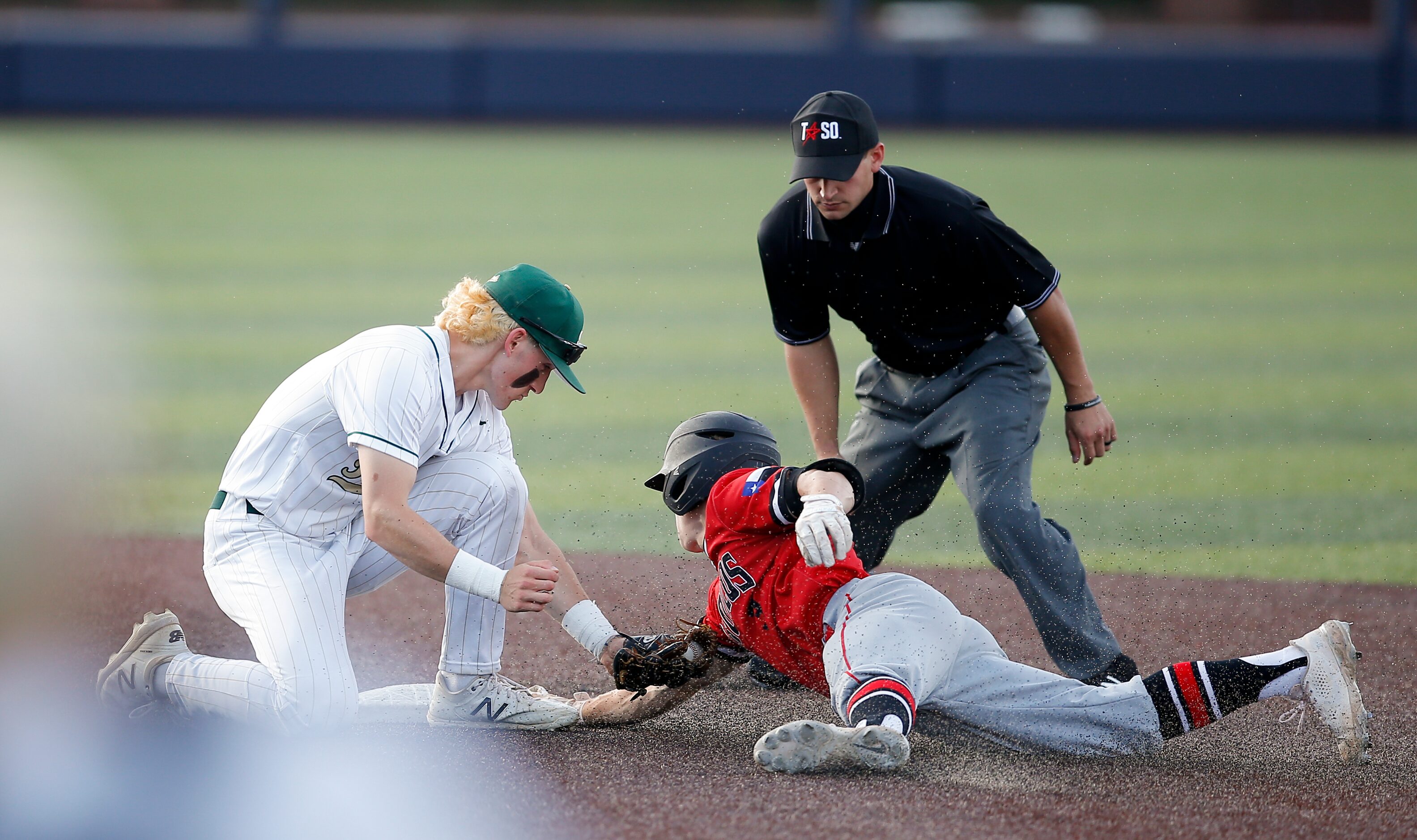 Birdville’s Logan Lacey, left, is unable to make the tag as Mansfield Legacy’s Easton...