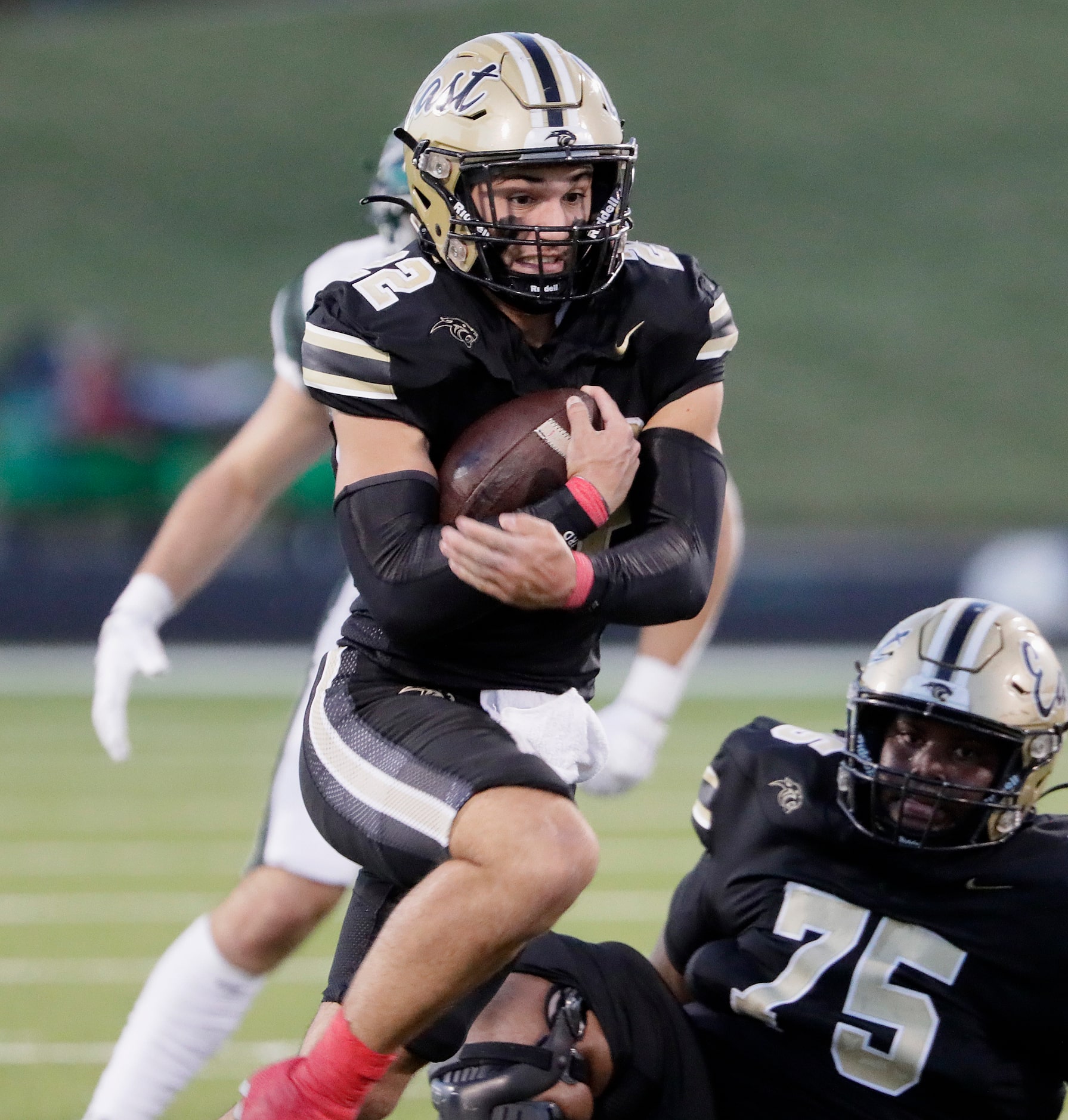 Plano East High School running back Travis Agee (22) runs the ball during the first half as...