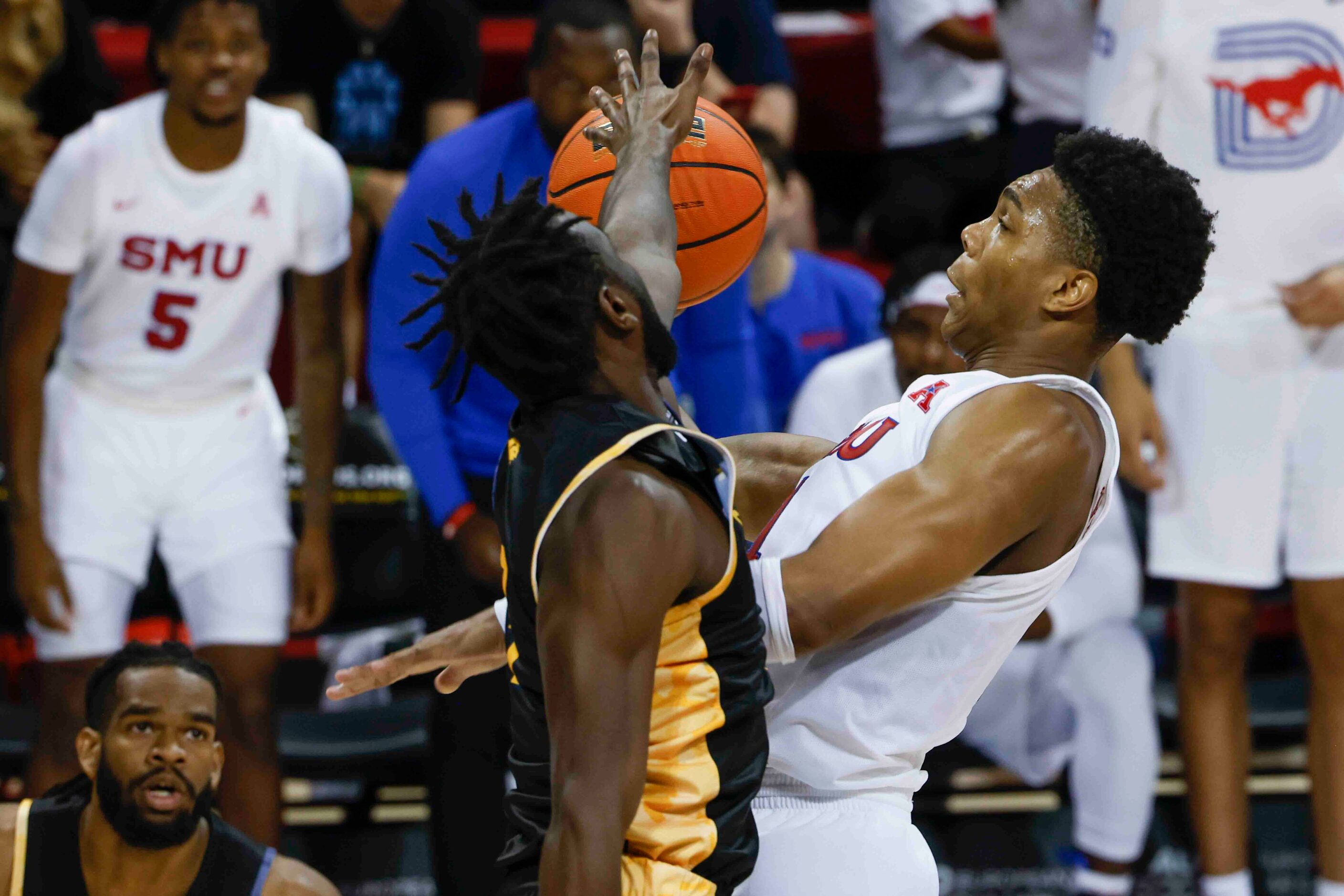 Texas A&M-Comm’s guard Tommie Lewis (3), left, blocks Southern Methodist guard Zhuric Phelps...