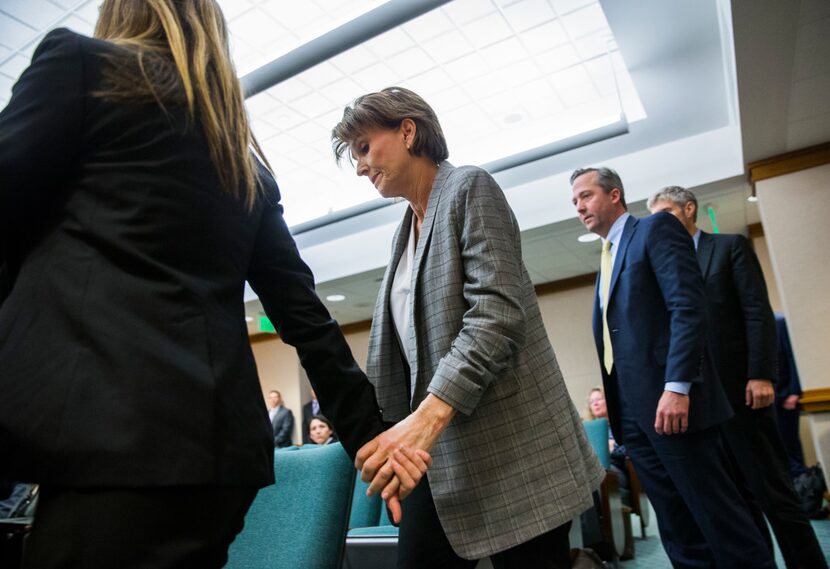 Eve Wiley (left) and her mother, Margo Williams walk to the front of the room to testify...