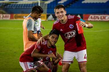 Brecc Evans (4) and Gibran Rayo (39) celebrate a 4-0 win in North Texas SC's final regular...