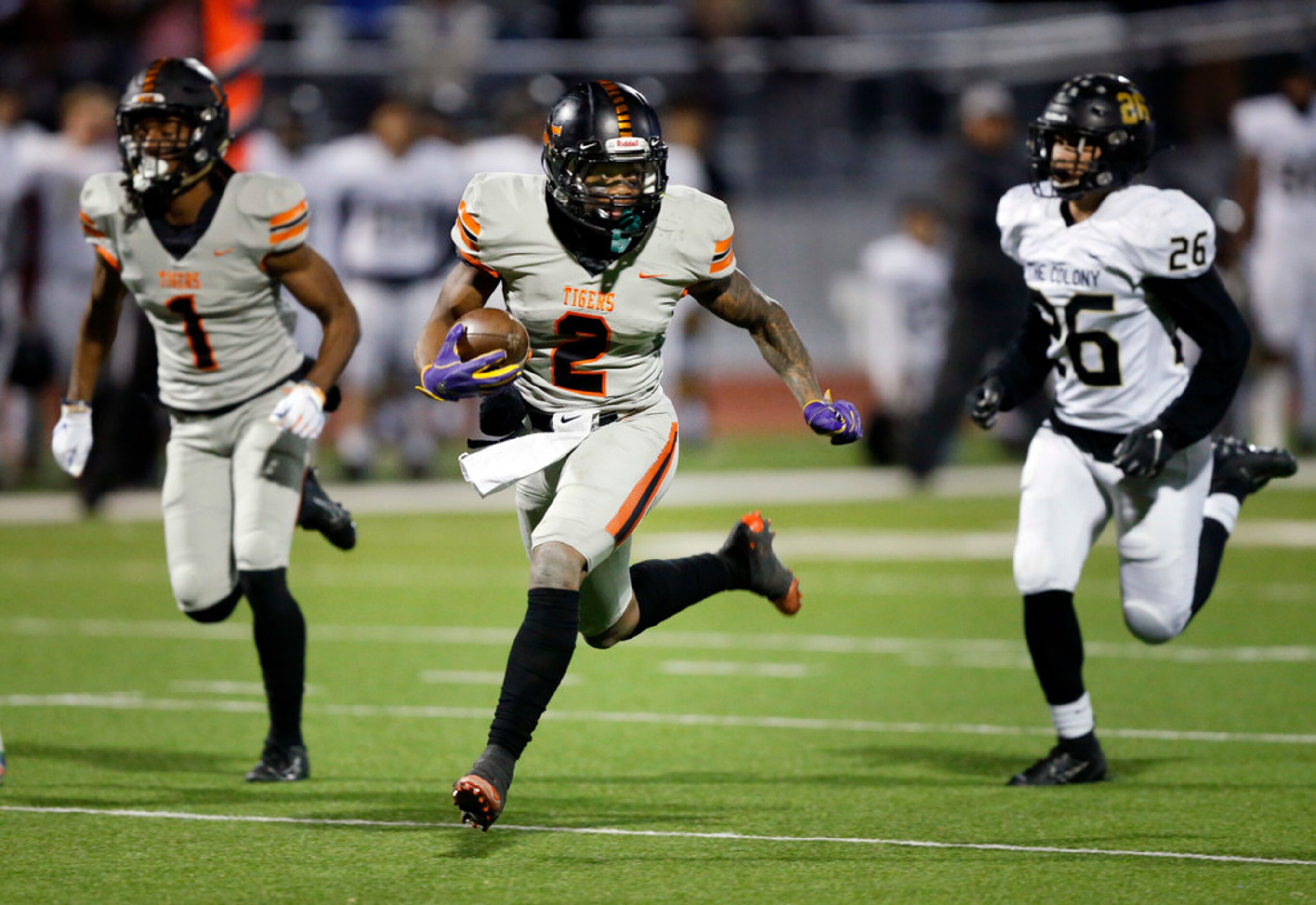 Lancaster running back Tre Bradford (2) runs away from The Colony's Jose Escobedo (26) for a...