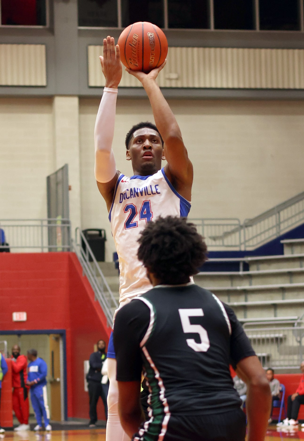 Duncanville forward Anthony Cook (24) shoots a jump shot as DeSoto guard Kayden Johnson (5)...