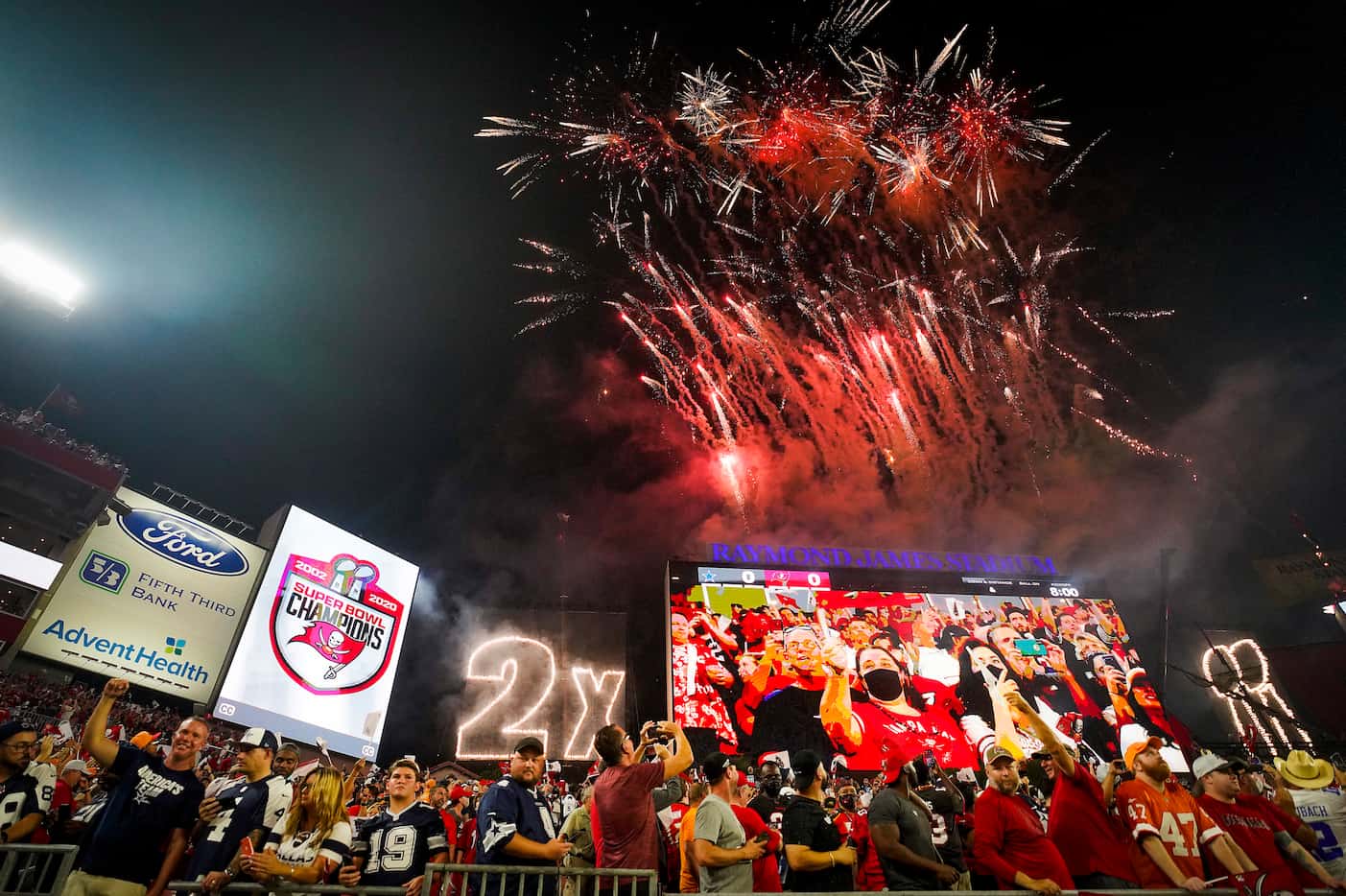 Tampa Bay Buccaneers fans cheer the recognition of their 2020 Super Bowl title before an NFL...