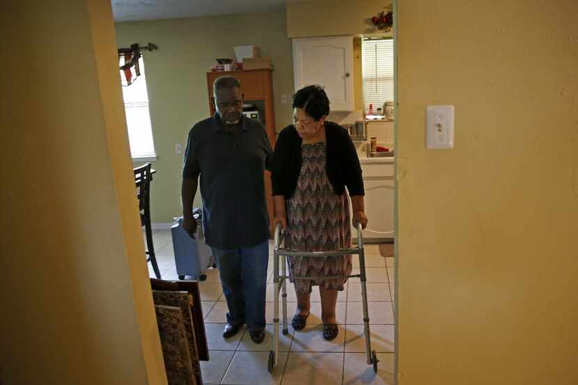 Charlie Wilson helped his wife walk at their home in Duncanville in April. (Jae S. Lee/The...