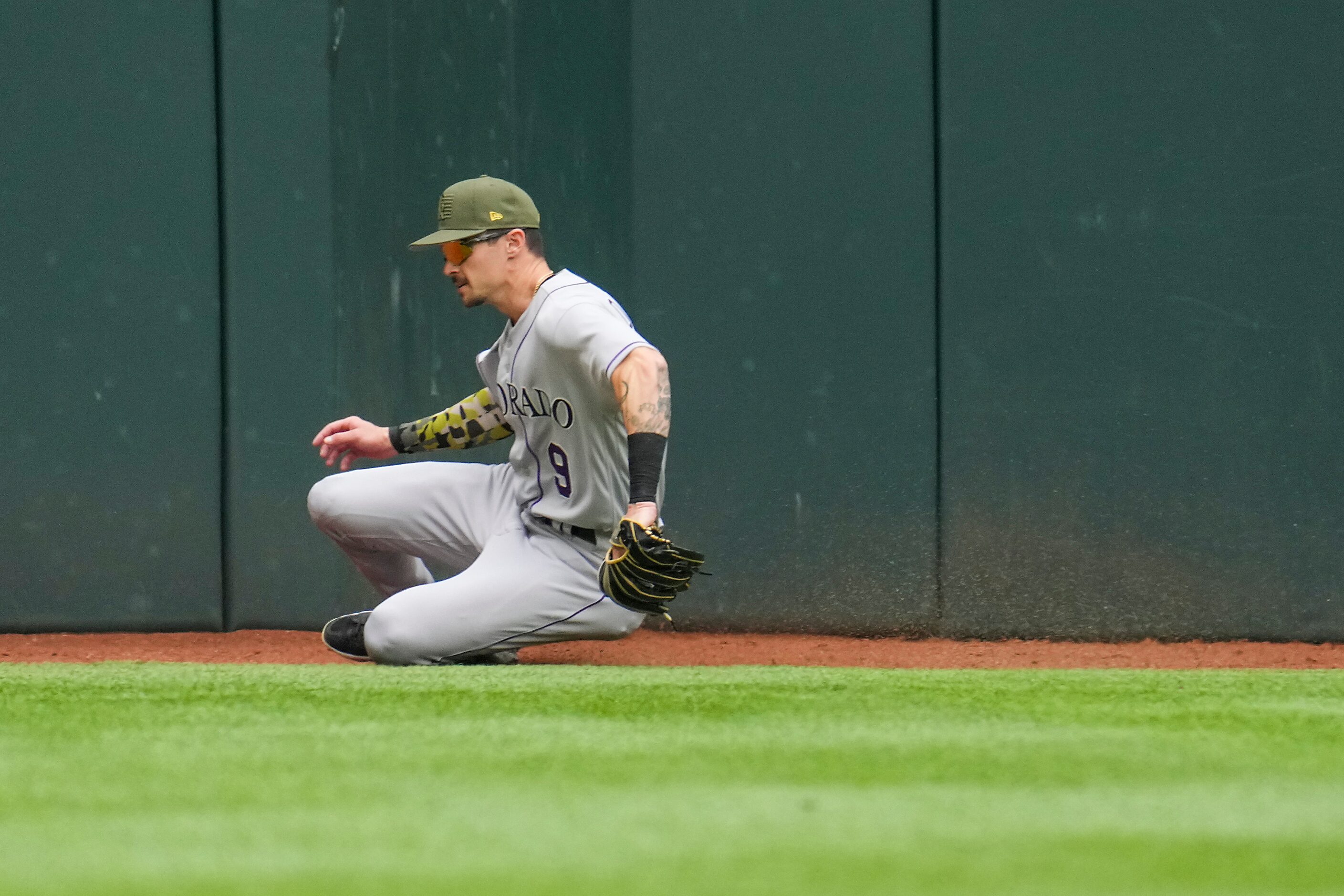 Colorado Rockies center fielder Brenton Doyle chases down a double off the bat of Texas...