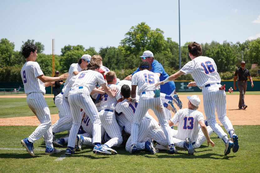 Trinity Christian players dogpile after defeating Houston St. Thomas, 7-6, during the TAPPS...
