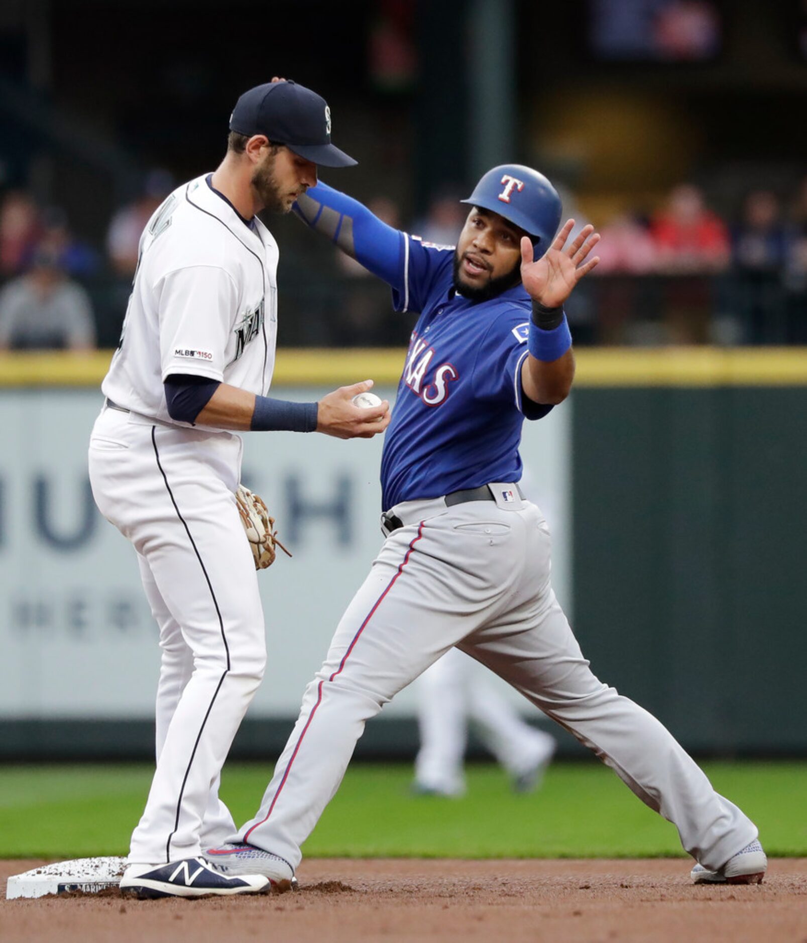 Texas Rangers' Elvis Andrus, right, turns to ask for time after stealing second base as...