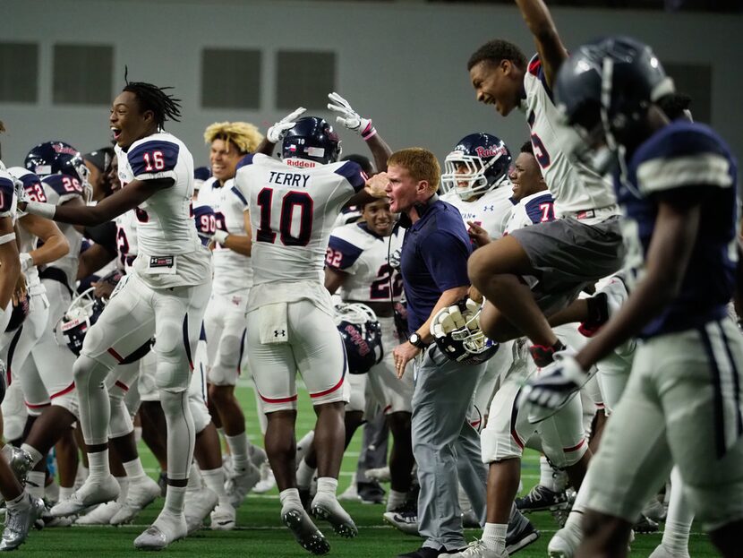 The Ryan High School football players celebrate after they defeat Frisco Lone Star at The...