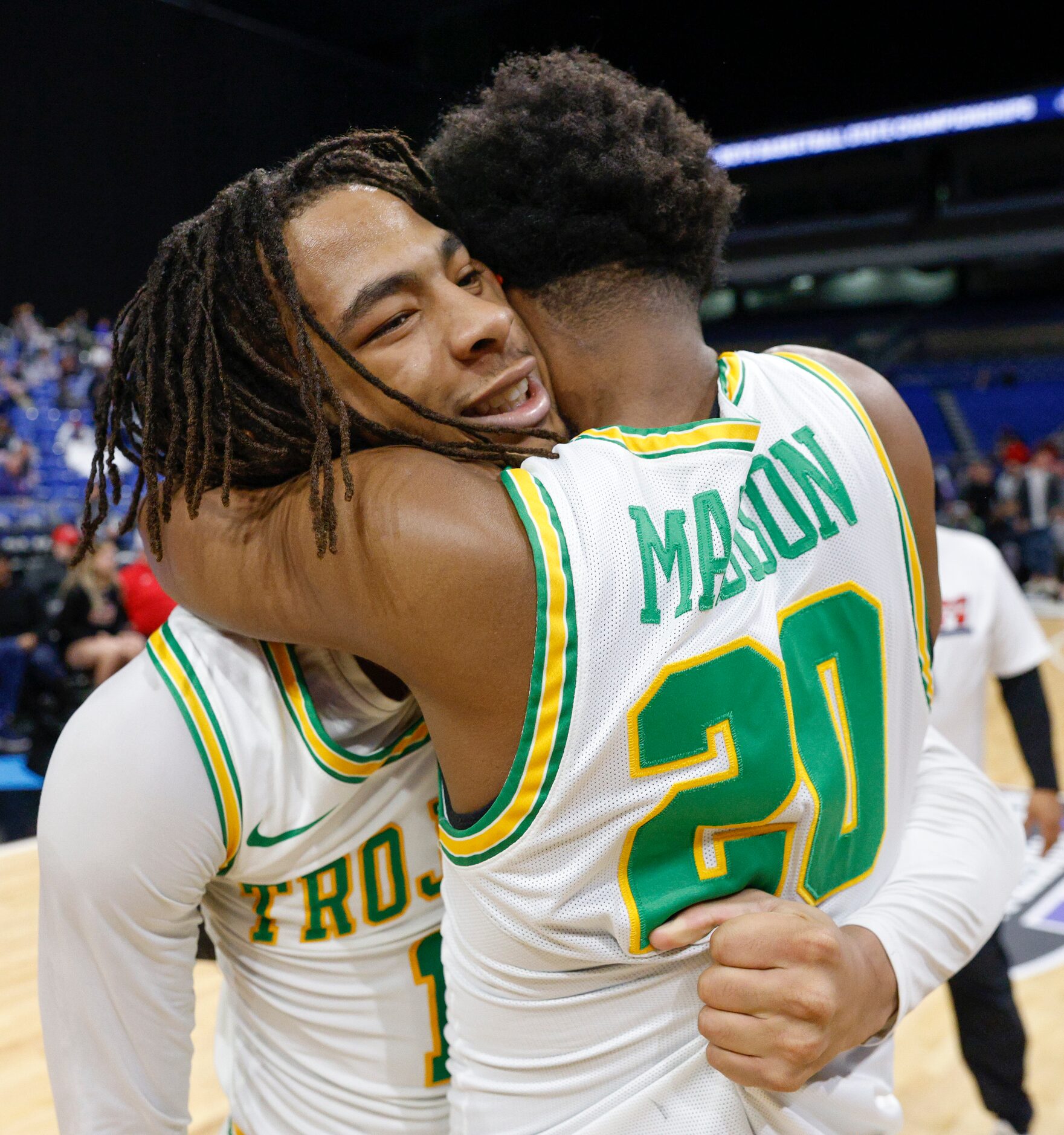 Madison guard Pierre Hunter (1) hugs Madison guard Jordan McCullough (20) after winning the...