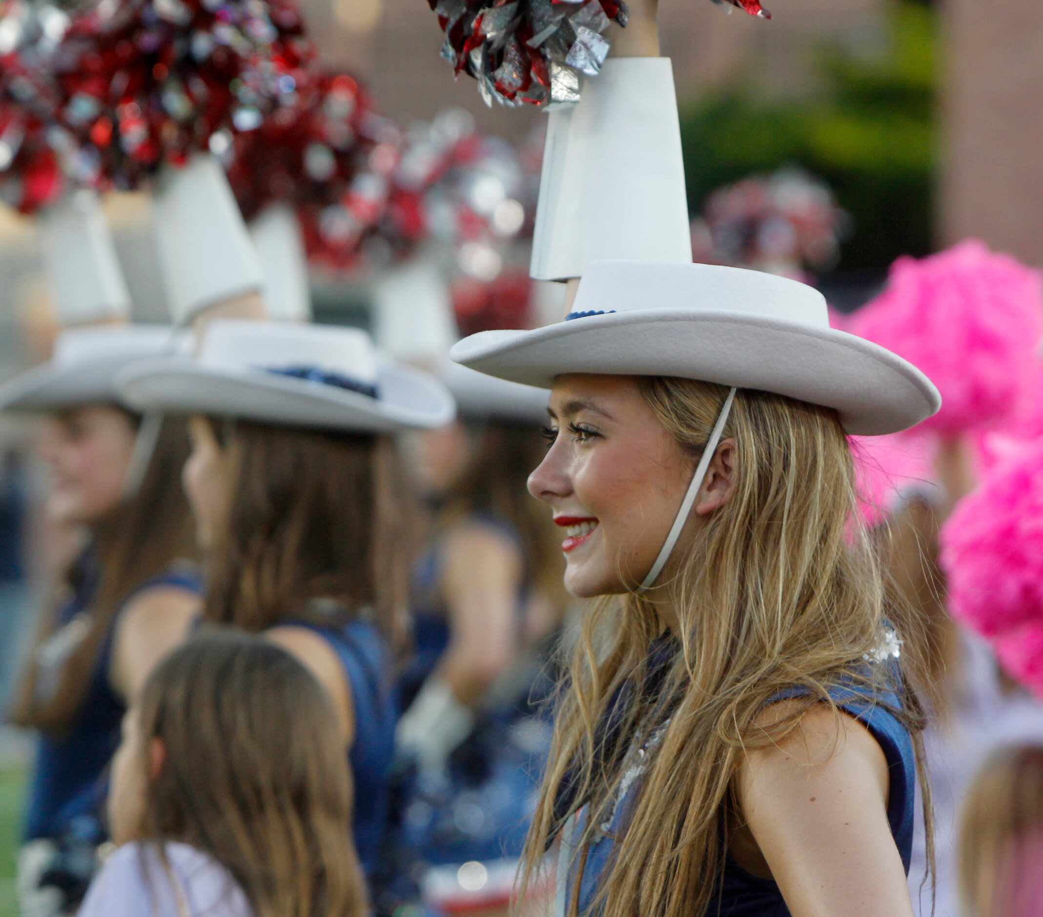 Allen drill team members perform on the field prior to the opening kickoff of their game...