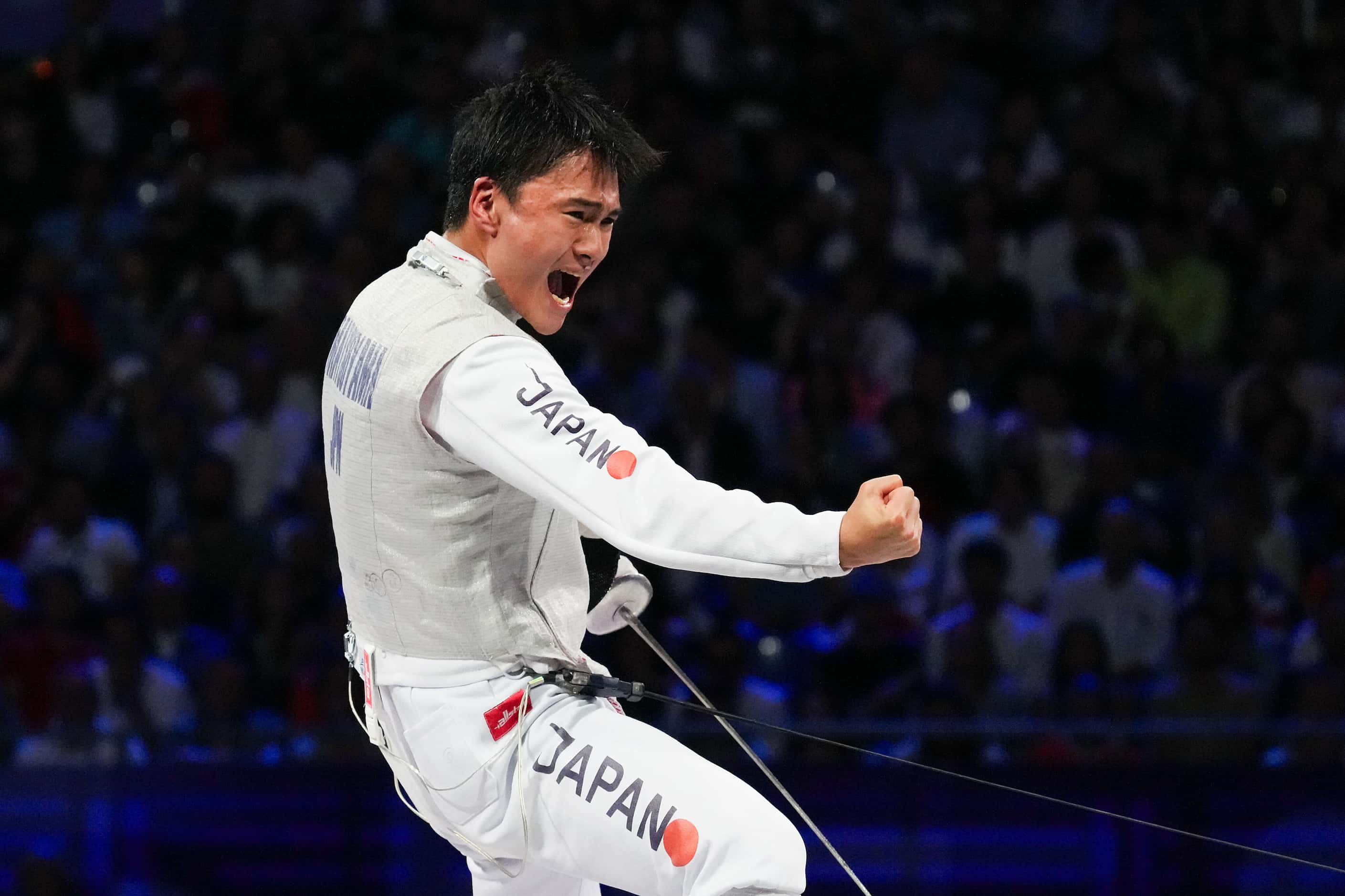 Kyosuke Matsuyama of Japan celebrates a point during the men's foil team gold medal match...