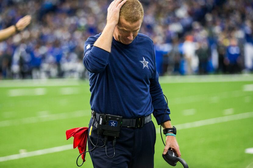 Dallas Cowboys head coach Jason Garrett puts his hand on his head after officials called a...