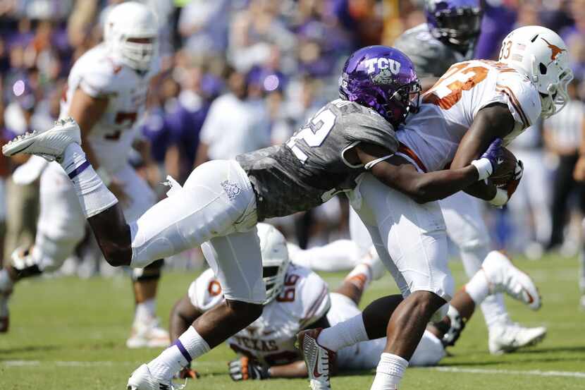 Texas Longhorns running back D'Onta Foreman (33) is tackled by TCU Horned Frogs linebacker...