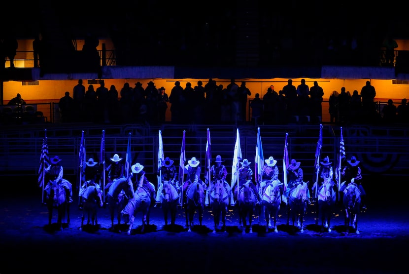 Ladies on horseback, known as pivot setters, bow their heads in prayer as they hold the six...