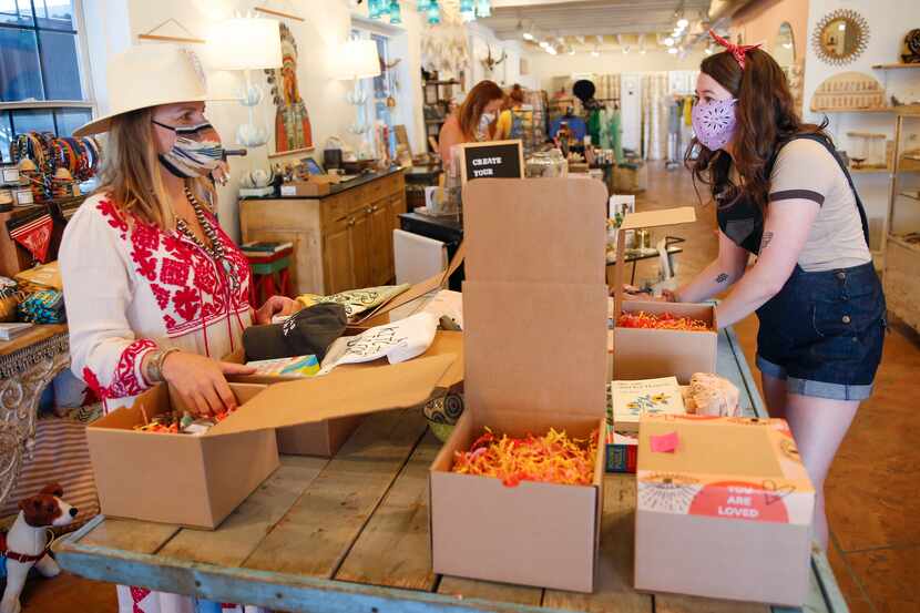 Owner Carley Seale, left, helps pack up orders with Mary Walton at Favor The Kind store in...