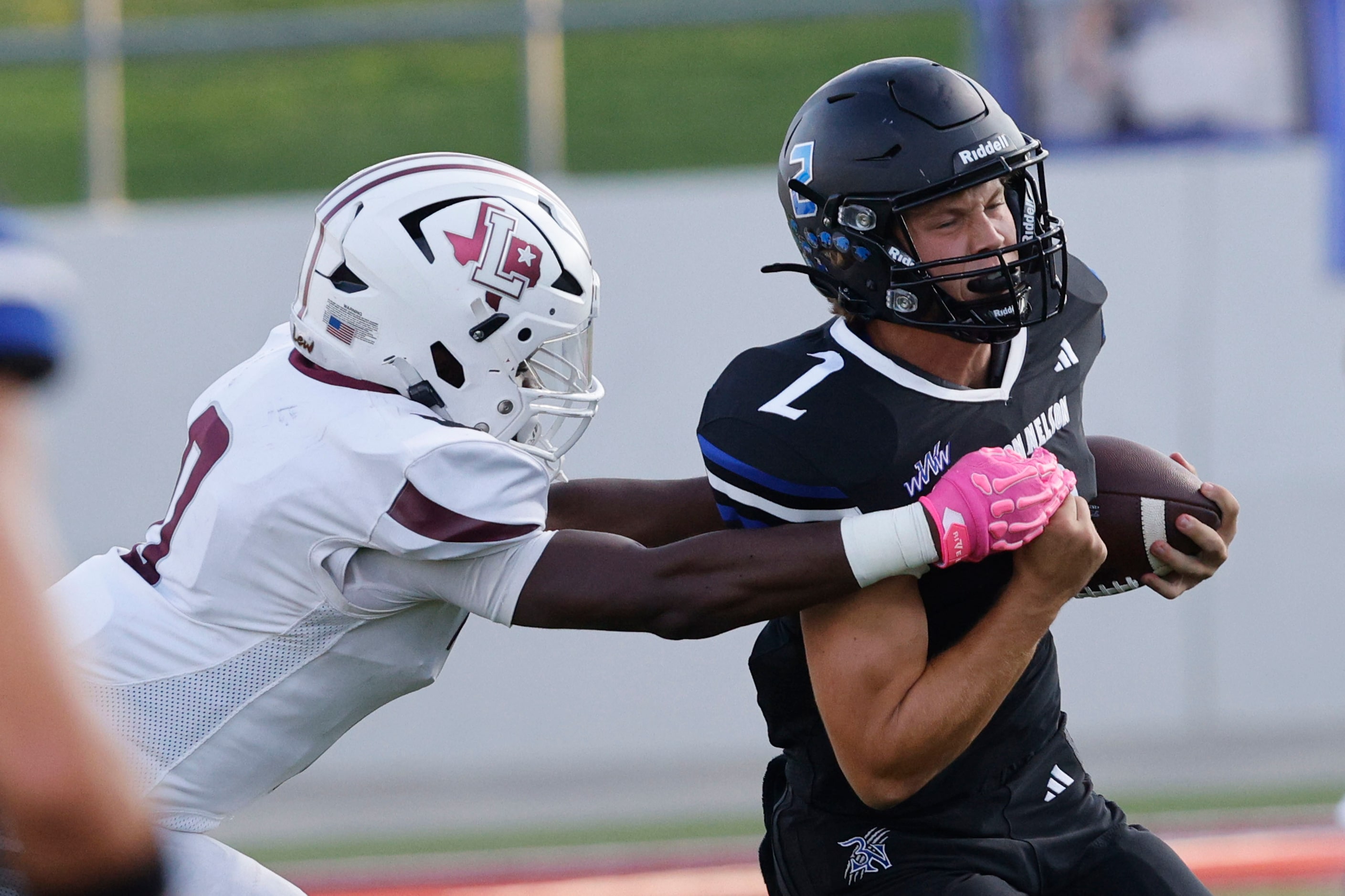 Lewisville's Devin Robinson (0) tries to stop Byron Nelson's quarterback Grant Bizjack (2)...