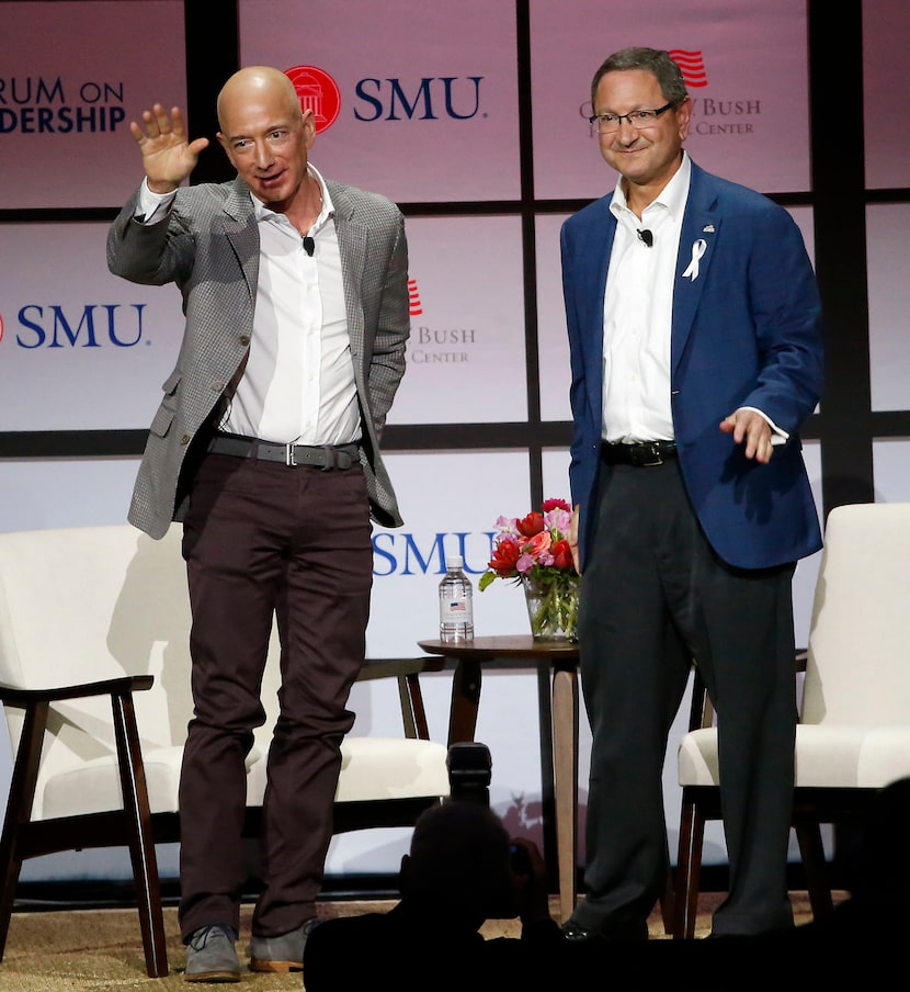 Jeff Bezos, Chairman and CEO of Amazon, waves to the crowd next to Ken Hersh, president and...