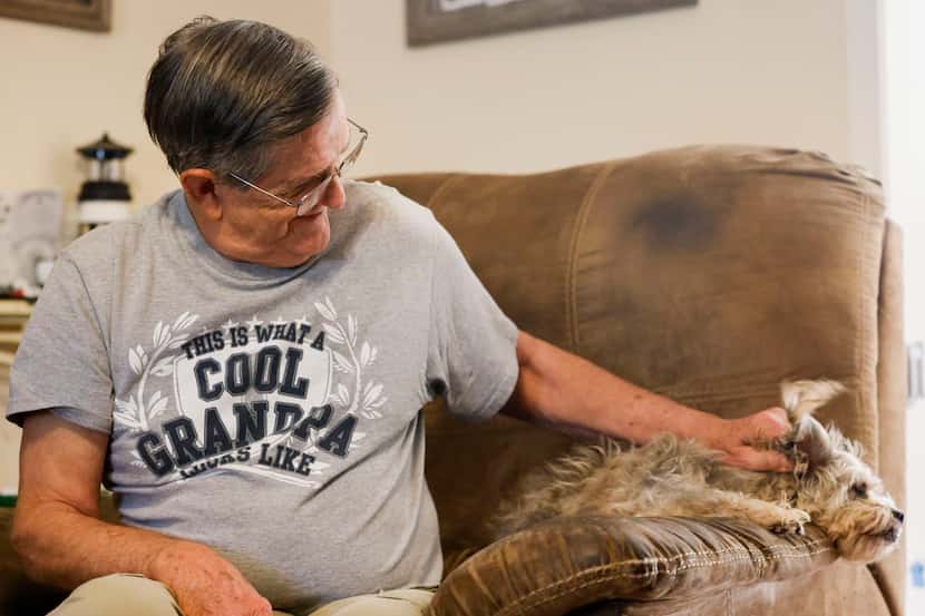 Fredie Joe Williams gets pets his dog, Chip, while sharing stories about his wife, Josie...
