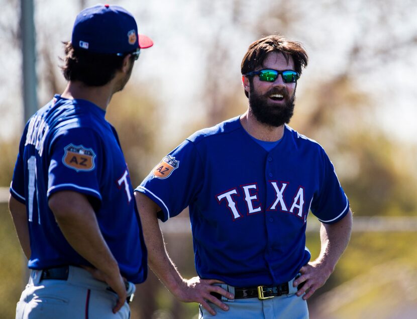 Texas Rangers starting pitcher Yu Darvish (11) and starting pitcher Cole Hamels (35) laugh...