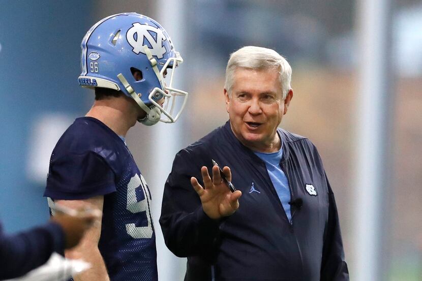 FILE - In this March 3, 2019, file photo, North Carolina head coach Mack Brown talks with...