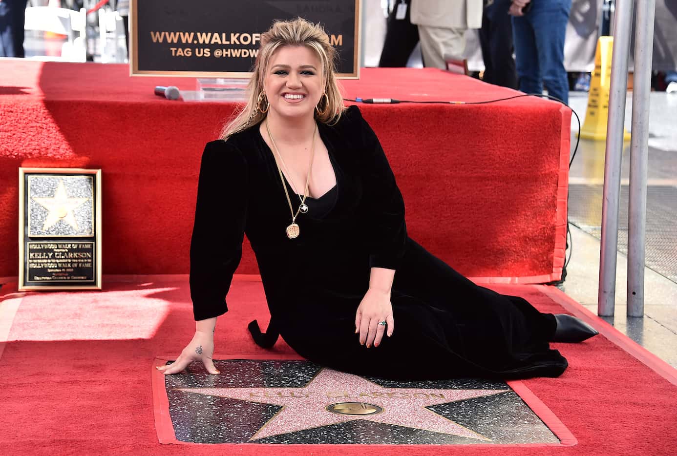 Singer and talk show host Kelly Clarkson poses atop her new star on the Hollywood Walk of...