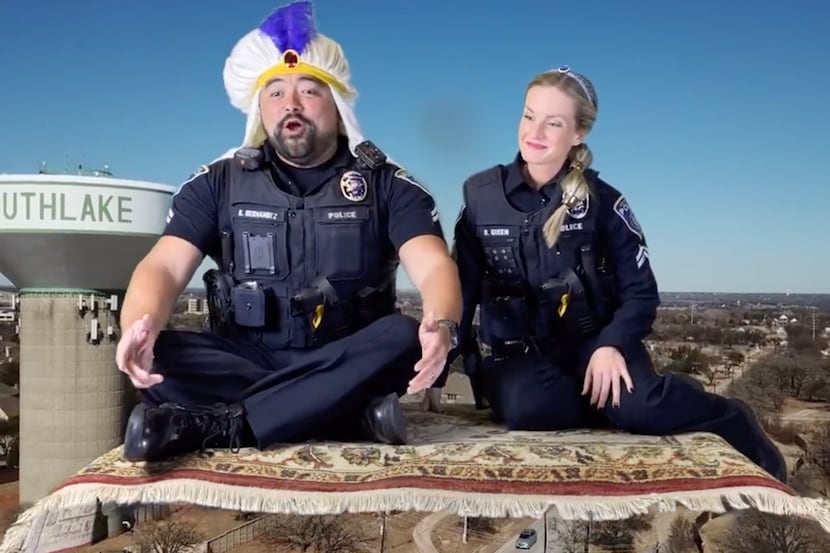 The officers sit on a carpet floating through the city and sing “A Whole U-Turn” to the tune...