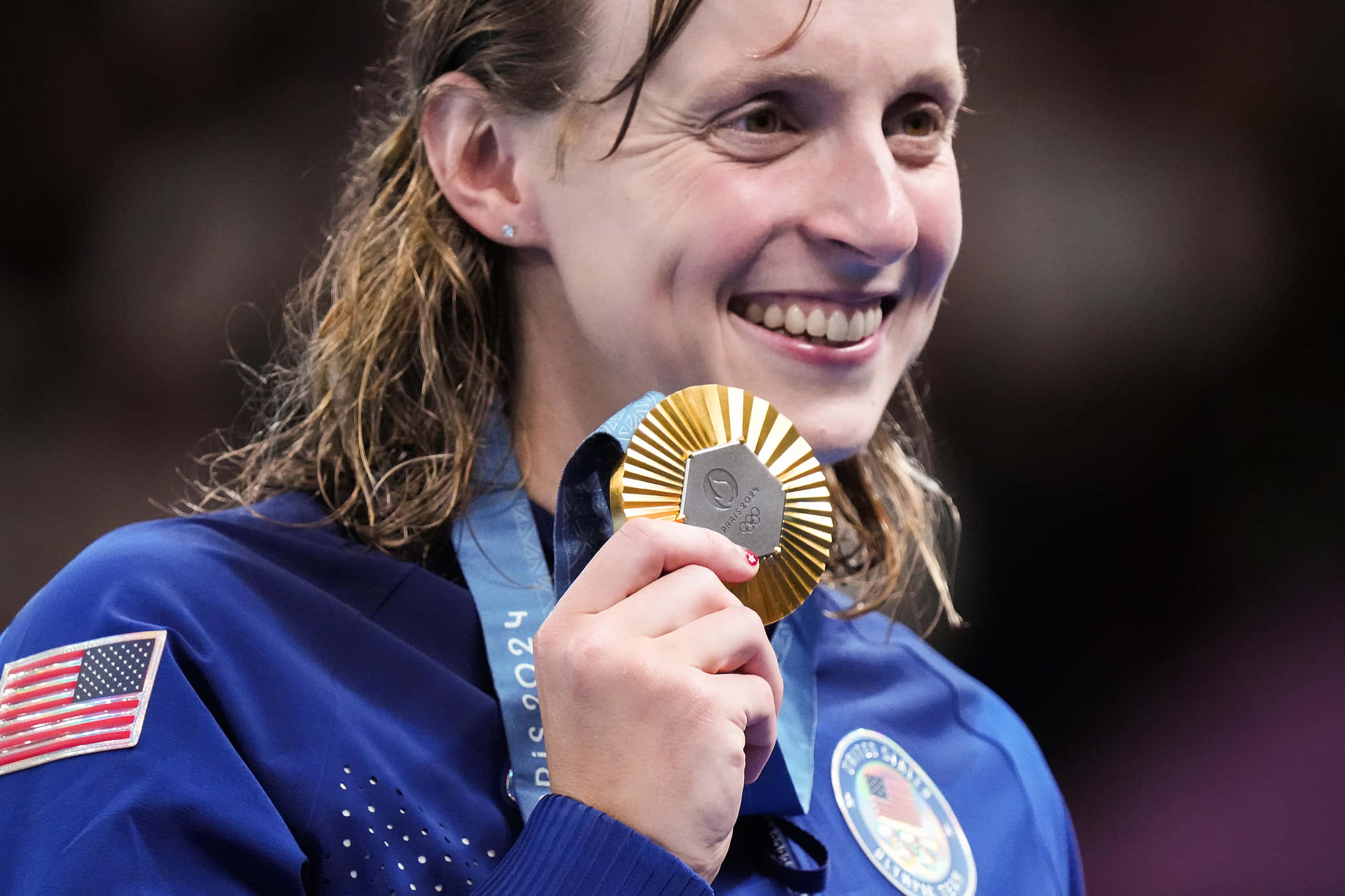 Katie Ledecky of the United States poses with her gold medal after winning the women's...