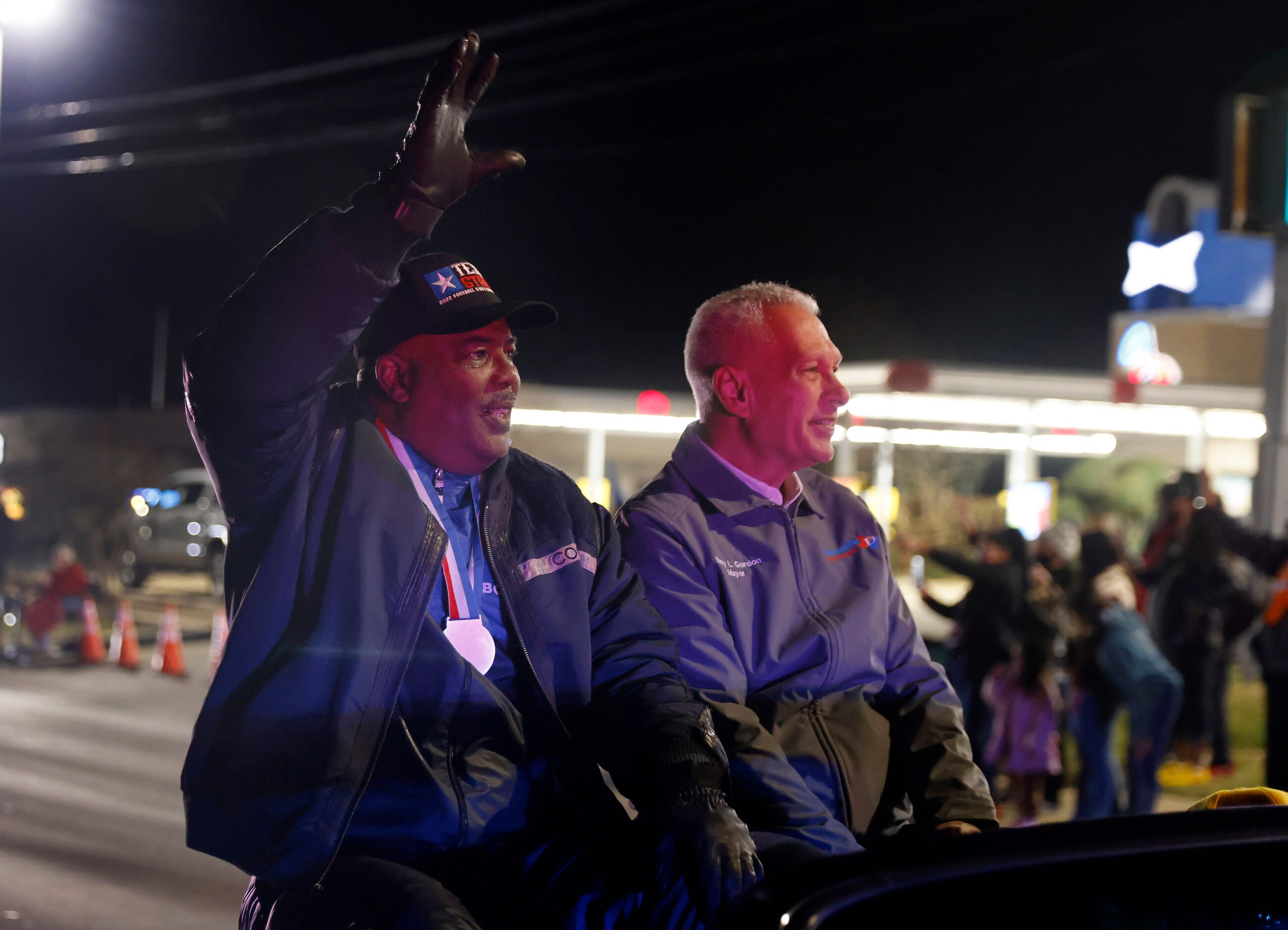 Duncanville High head football coach Reginald Samples (left) waves to fans as he rode in a...