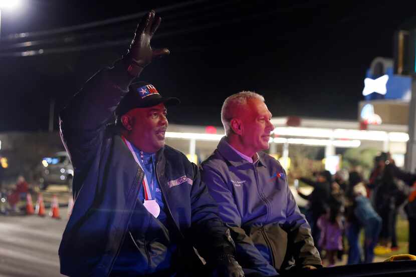 Duncanville High head football coach Reginald Samples (left) waves to fans as he rode in a...